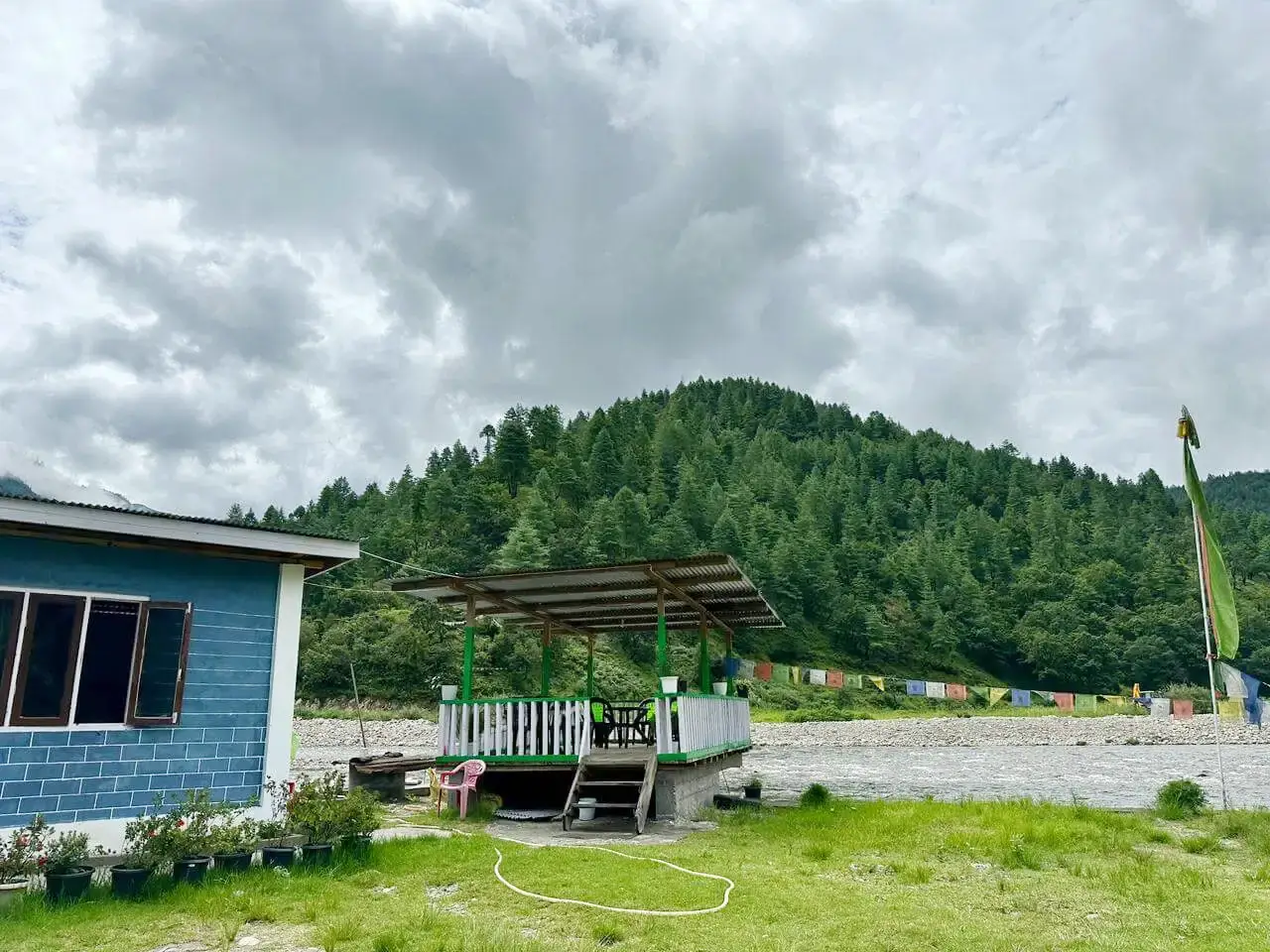 Riverside facilities and blue house at Sangti Tsomka Dirang
